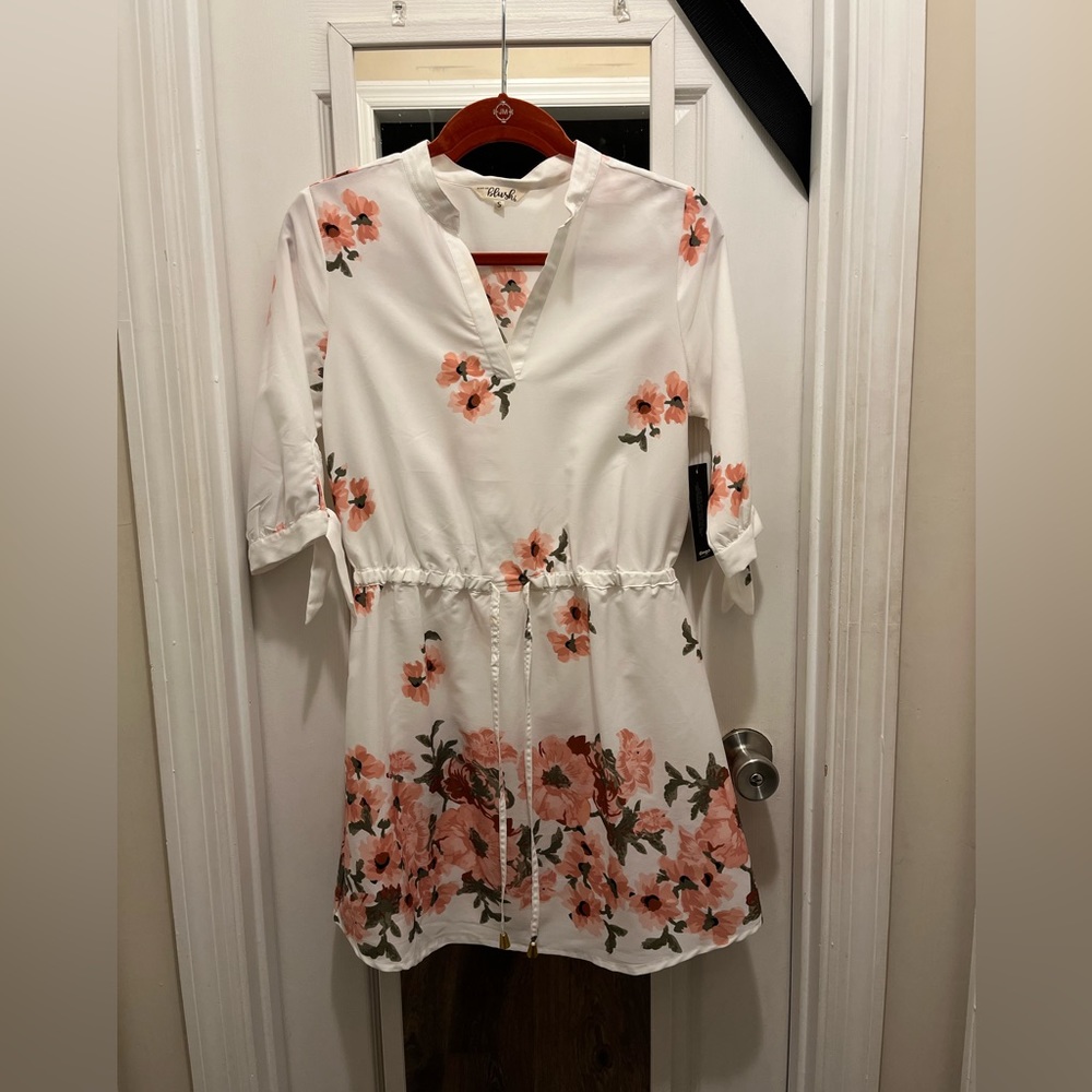 Blush mini floral dress. Has tag but has a lite stain from trying on.